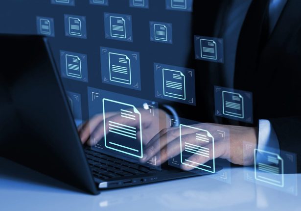 Online documentation database and document management system concept. Business person working on laptop with virtual screen. Process automation to efficiently manage files. Online documentation database and document management system concept. Business person working on laptop with virtual screen. Process automation to efficiently manage files